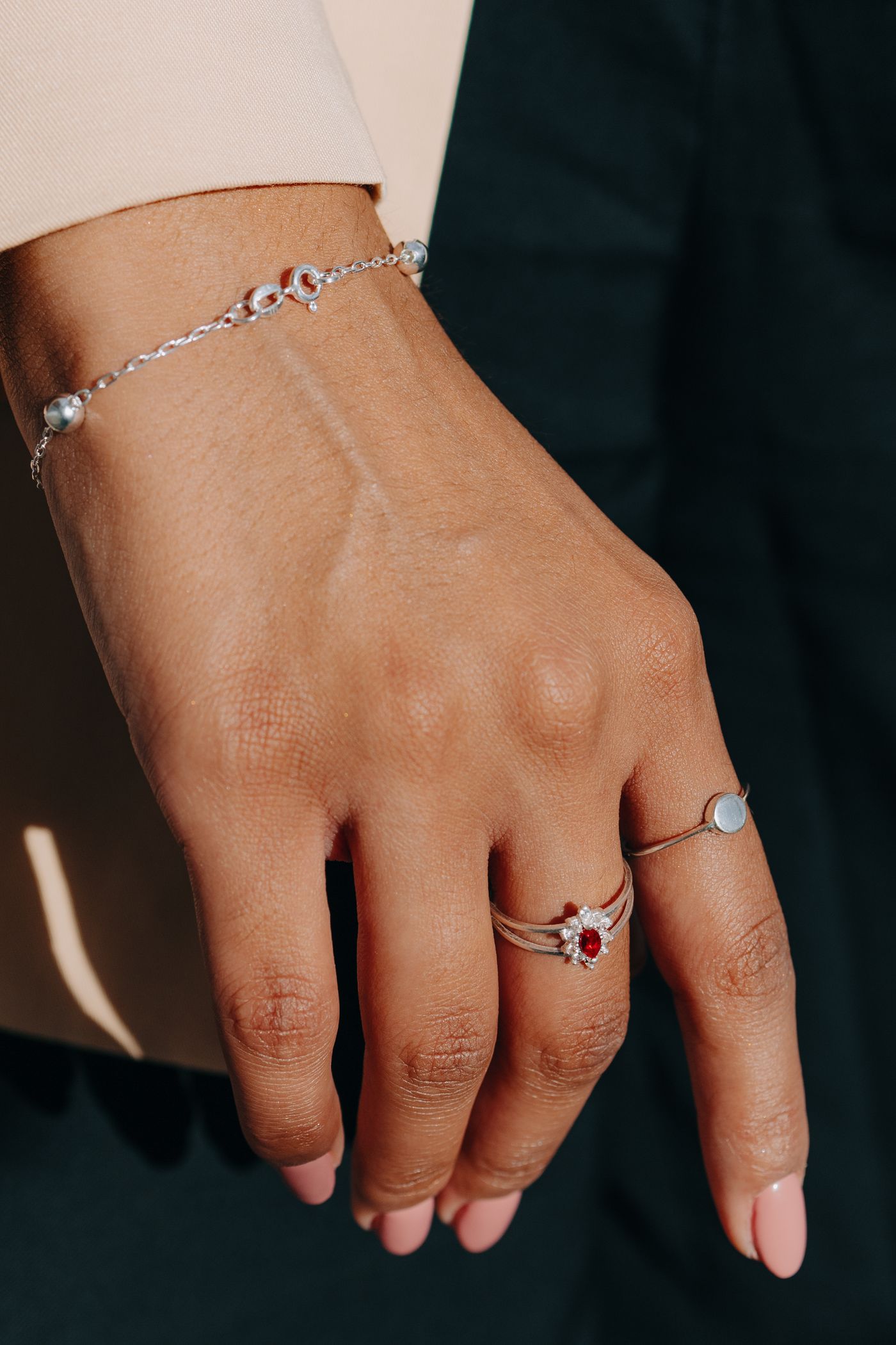 Close-up of jewelry styling with bracelets and rings